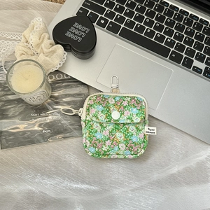 Macro detail of floral mini storage pouch with metal hook and snap button pocket