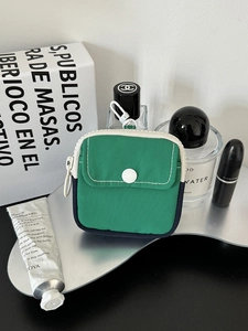 Portable mini green fabric coin purse and headphone storage pouch with white clip hook