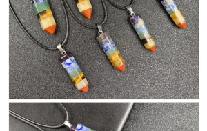 Detail of multi-layer natural stone hexagonal pendant with silver clasp and black cord