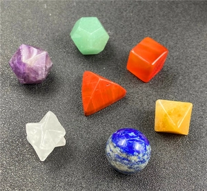Macro view of seven assorted natural crystal geometric shapes on dark textured background