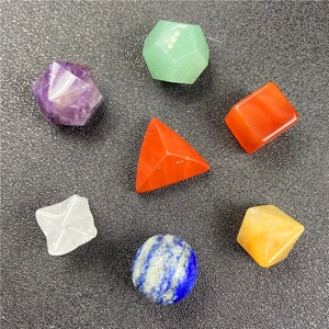 Macro shot of 7 colorful geometric crystal stones including quartz sphere and cubes