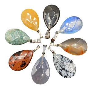 Faceted teardrop crystal pendant set with diverse natural stones and silver metal loops