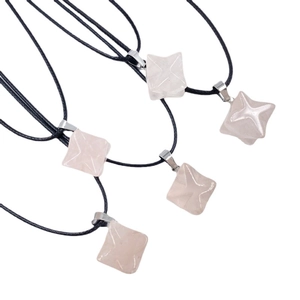 Five Rose Quartz Merkaba Star pendants with black cords on a plain white background