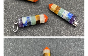 Detailed macro view of seven chakra hexagonal crystal pillar pendant with silver clasp