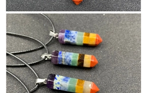 Macro detail of hexagonal 7 chakra crystal point pendants on black wax cord necklaces