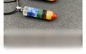 Macro detail of hexagonal 7 chakra healing stone pendant with braided necklace cord