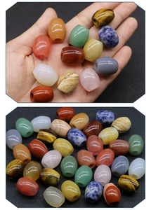 Macro detail of assorted 16x18mm natural stone barrel beads for DIY jewelry making