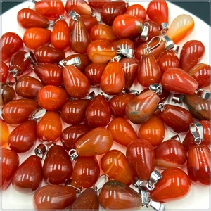 Collection of red agate water drop pendants with silver clasps on white background