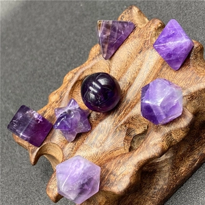 Set of 7 amethyst geometric crystals on wooden base for healing and teaching