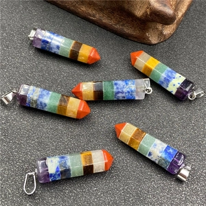 Seven chakra stone hexagonal column pendants with silver clasps on grey background