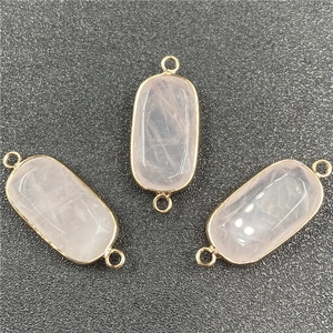 Rectangular natural rose quartz pendant with gold plated edge and double connector rings