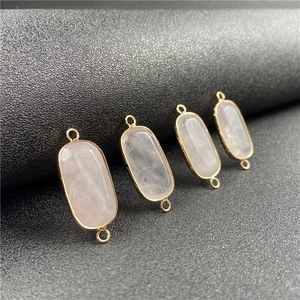 Set of four rectangular rose quartz pendants with gold-plated edges and double loops