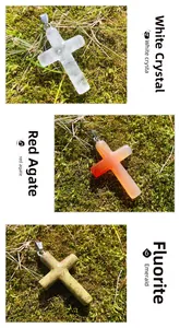 Detailed view of cross pendants in white crystal, red agate and unakite stones