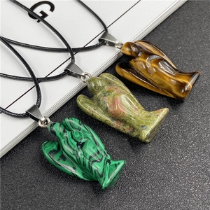 Close-up of angel pendants in tiger eye, unakite, and malachite stones on cord