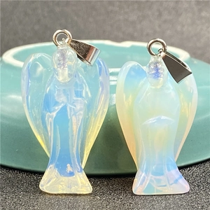 Detail of opalite angel pendants with silver clasps showing translucent milky white texture