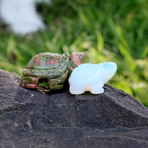 Close-up of hand-carved gemstone turtle figurines in natural ruby zoisite and opal stone