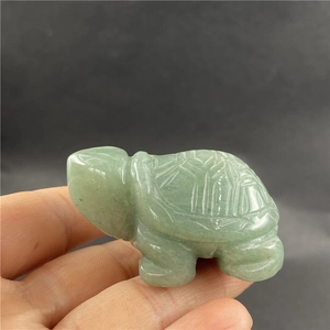 Detailed view of hand-carved green jade turtle ornament with intricate shell patterns