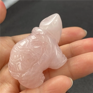 Detailed view of hand-carved rose quartz turtle figurine with polished crystal texture