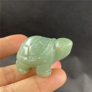 Macro view of a 2-inch hand-carved green aventurine turtle gemstone craft figurine