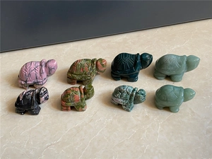 Top view of eight assorted natural gemstone turtle carvings with detailed shell textures