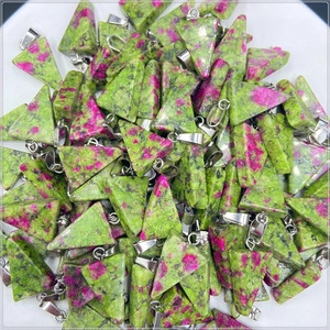 Polished triangular ruby zoisite pendants with silver bails on white background
