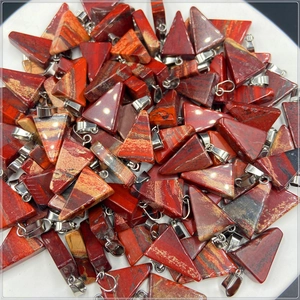 Detailed view of triangular red jasper pendants with silver bail in bulk collection