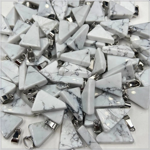 Macro shot of bulk triangle white howlite stone pendants with silver metal clasps