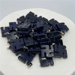 Close-up of blue goldstone religious symbol pendants with silver metallic clips