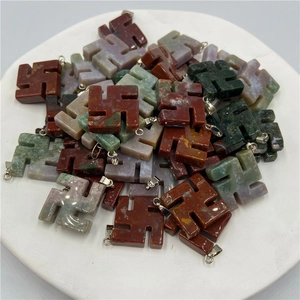 Natural stone swastika pendants in various colors like jasper and agate with metal clasps