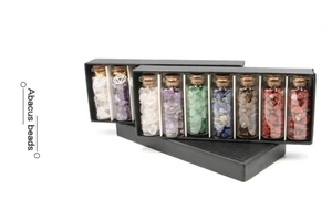 Macro shot of assorted natural crystal stone wishing bottles in a black gift storage box