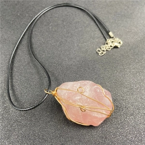 Natural rose quartz crystal pendant with golden wire wrap on black cord necklace