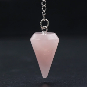 Natural rose quartz hexagonal cone dowsing pendulum with silver chain on black background