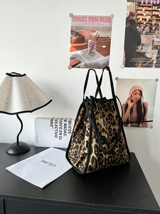 Detail of the leopard print canvas tote bag featuring premium textures and black straps