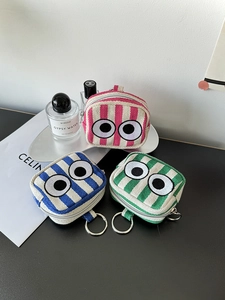 Three striped canvas mini pouches with large eye embroidery and silver metal hardware