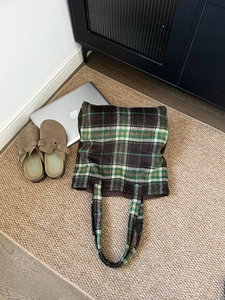 Top-down view of a large plaid wool tote bag with green and brown checkered pattern