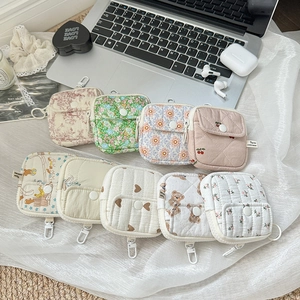 Nine mini quilted storage pouches with floral, bear, and cherry patterns and clips