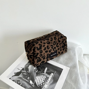 Macro shot of leopard print makeup bag showing the ribbed corduroy fabric texture