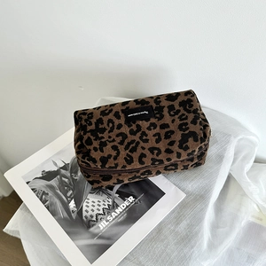 Close-up of leopard print corduroy makeup bag showing texture and zipper detail