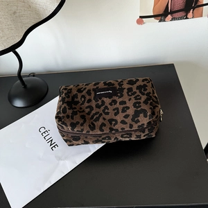 Close-up of leopard print corduroy makeup bag texture with premium metal zipper detail