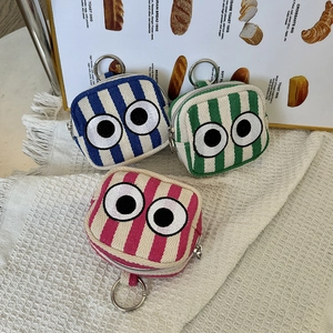 Mini embroidered canvas coin purses with striped patterns and eye patches on metal rings