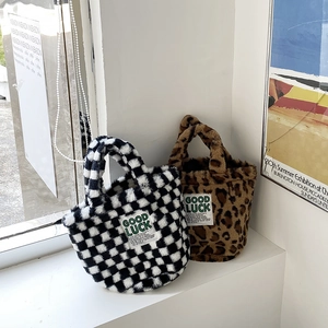 Chic plush bucket handbags featuring checkerboard and leopard patterns with Good Luck tag