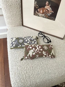 Floral embroidered storage bags with vintage zippers on a cozy fleece background
