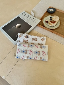 Quilted cosmetic bags with teddy bear and poodle prints on a wooden table setup