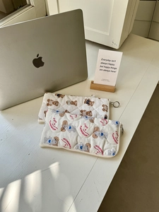Detail of quilted cotton pouches with bear and poodle prints and metal ring zippers