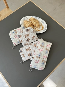 Close-up of quilted cotton pouches with cute bear and poodle prints and metal ring zippers