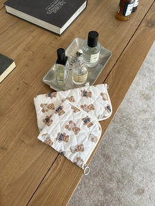 Detailed set of two quilted cotton organizers featuring cute bear prints on a wooden desk