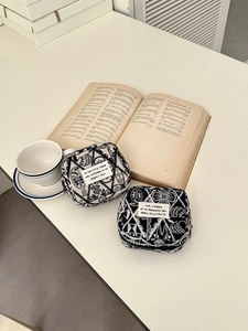 Detailed view of embroidered canvas card pouches with zipper on minimalist desktop