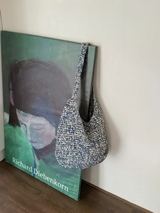 Detail of blue and beige handmade crochet weave on a bohemian style shoulder tote bag