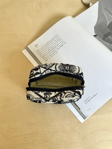 Detail showing the internal capacity of the mini canvas pouch with ethnic patterns