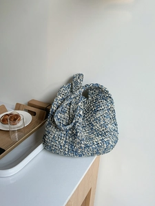 Detailed blue and white knit texture of the large capacity straw beach tote bag